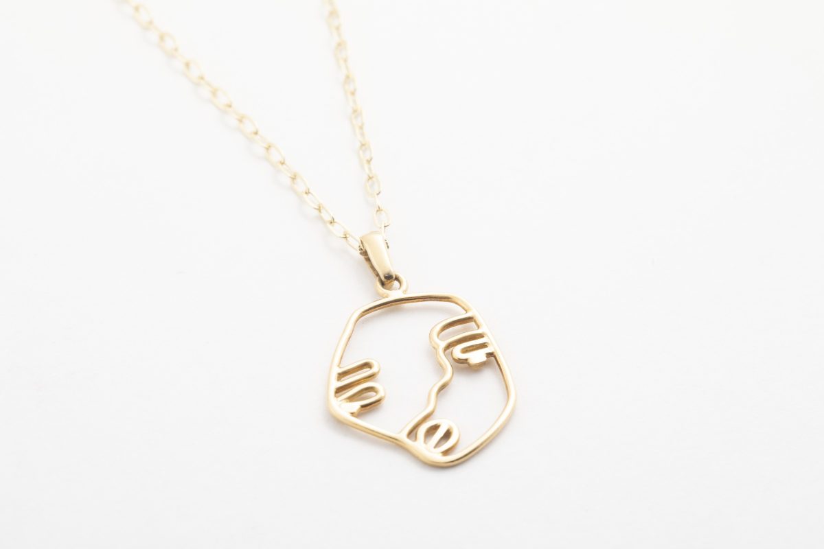 Dije de cara y cadena en oro amarillo